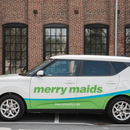 Merry Maids of Berks County branded car parked outside a brick building