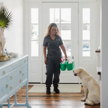 Merry Maids team member greeted by pet.