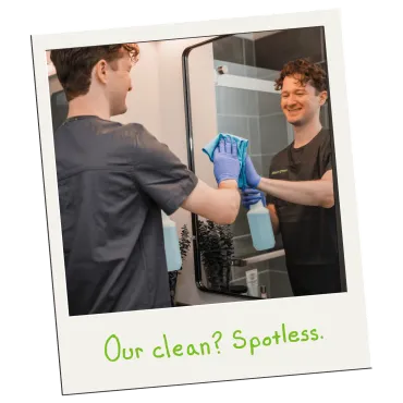 Merry Maids of Lancaster County cleaner polishing a bathroom mirror to a spotless shine.
