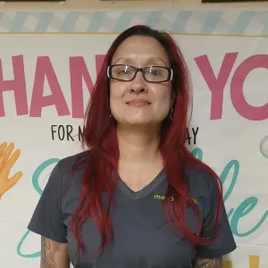 merry maids posing by a thank you sign